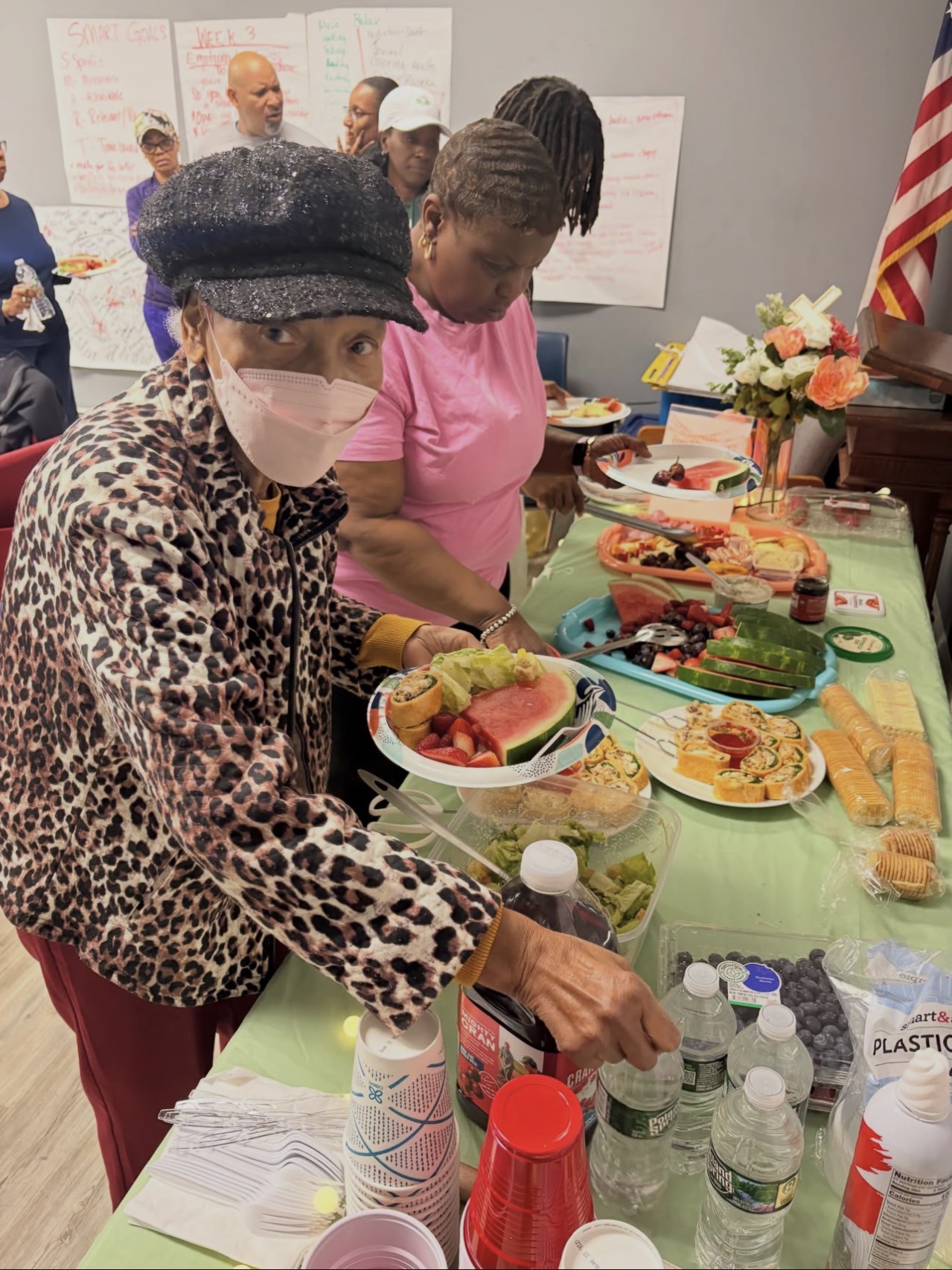 A member serving herself healthy food at a celebration table