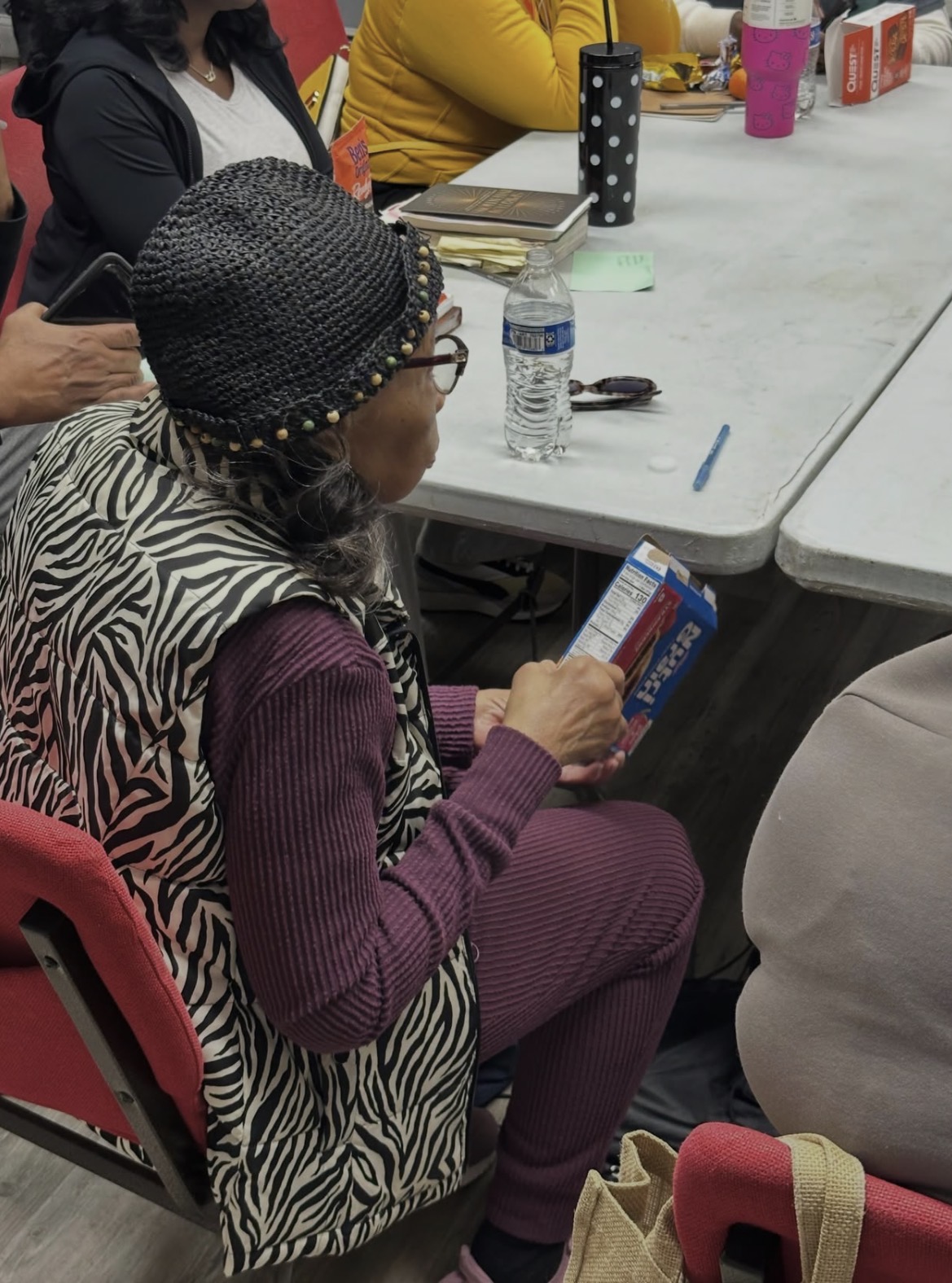 A group member reading a nutrition facts label